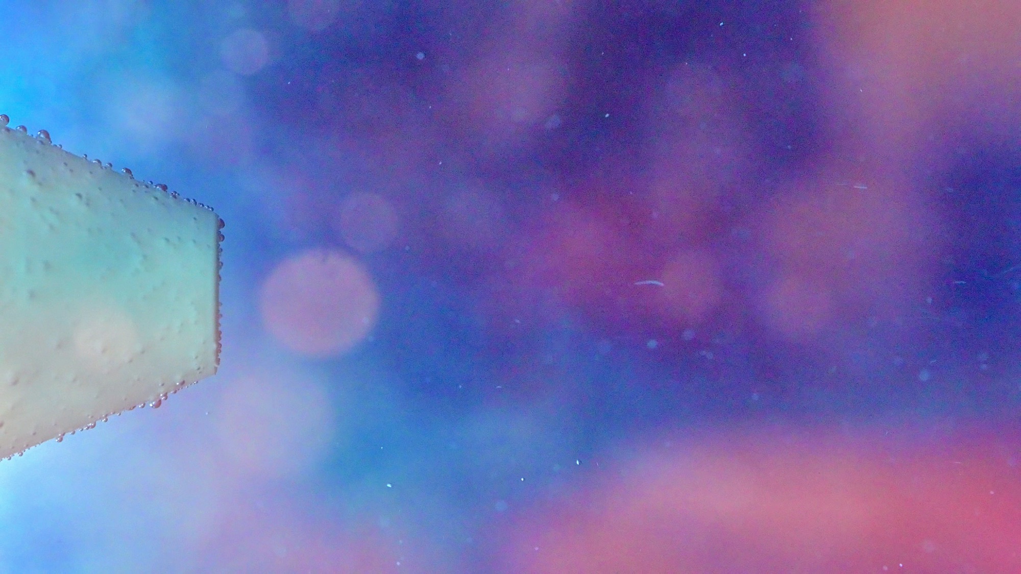 Abstract close-up of light through droplets on the nozzle housing