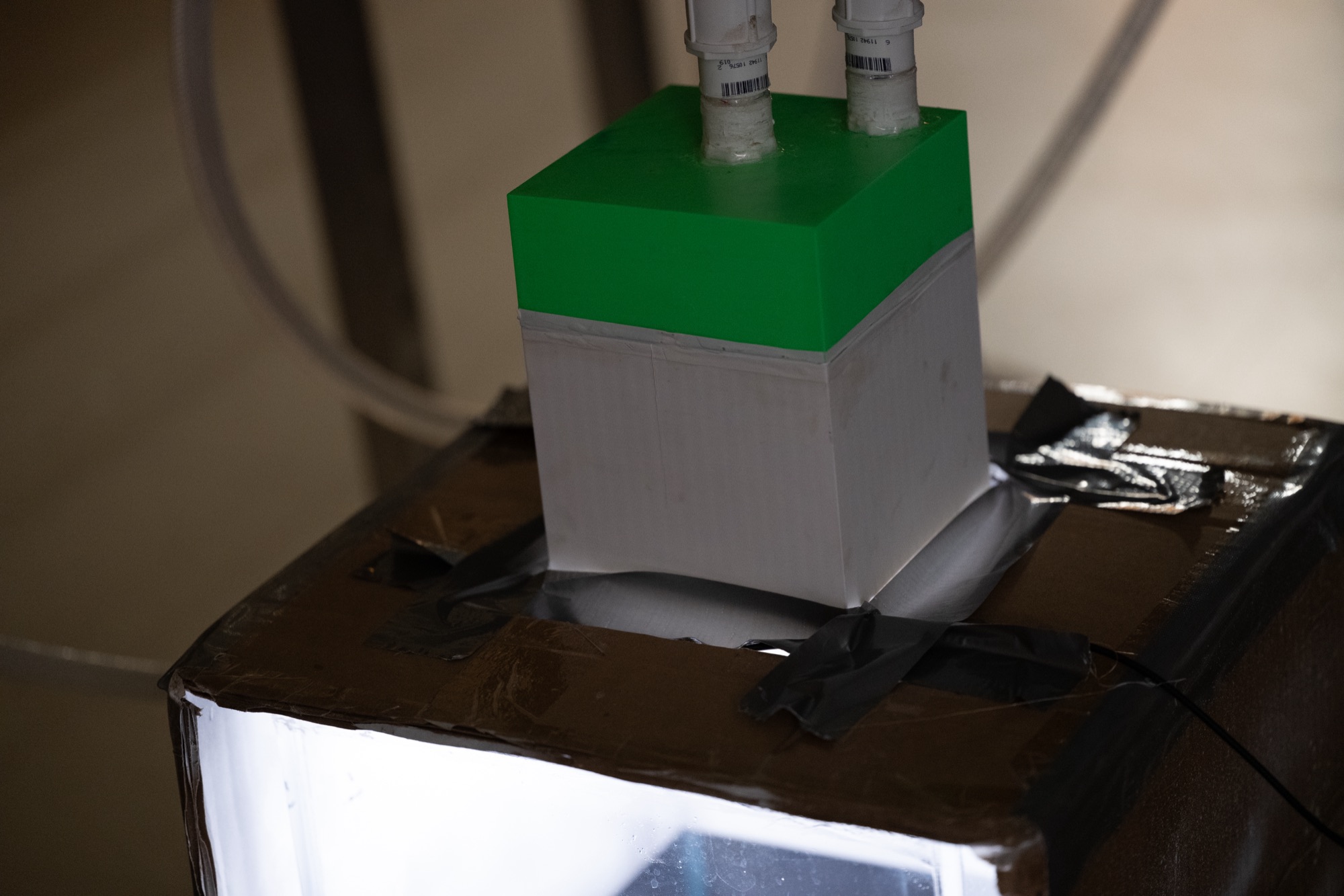 Swirler nozzle head mounted in the light box for flow visualization testing.